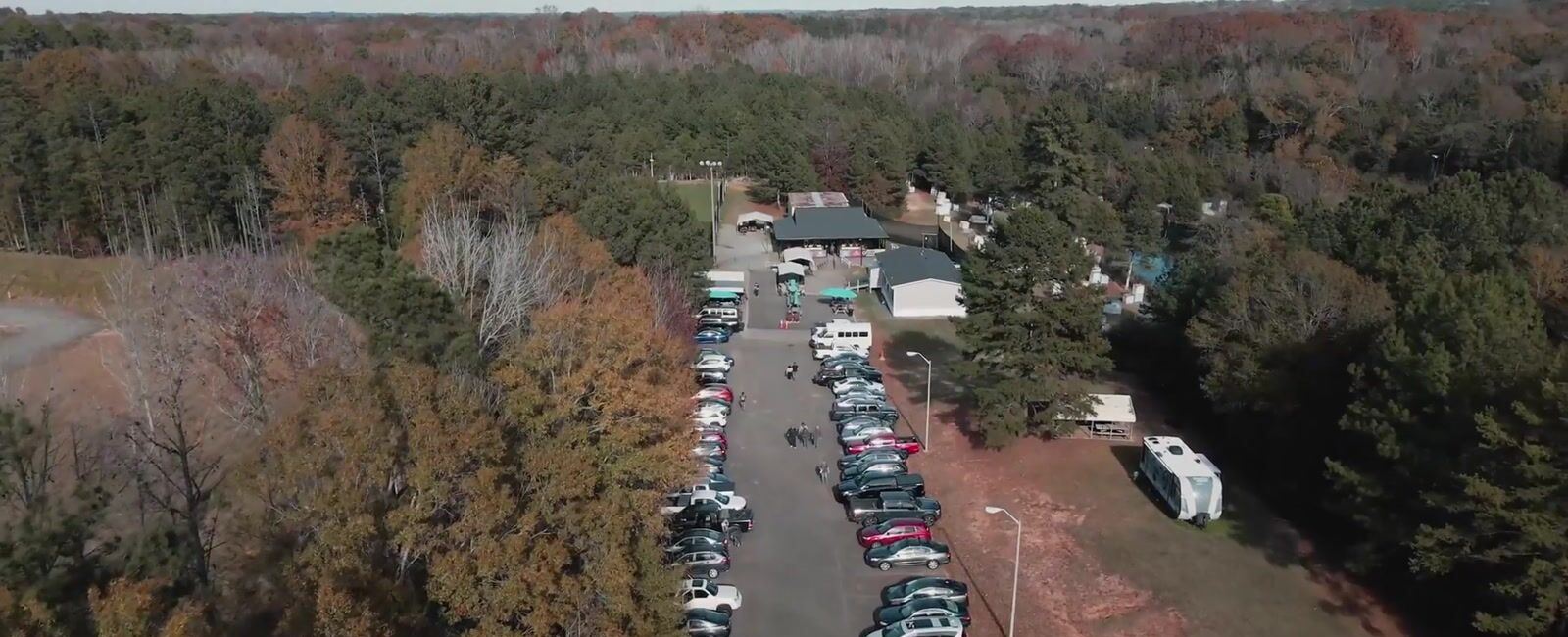 Aerial view of the tree-lined drive into Palmetto Hills on an event day