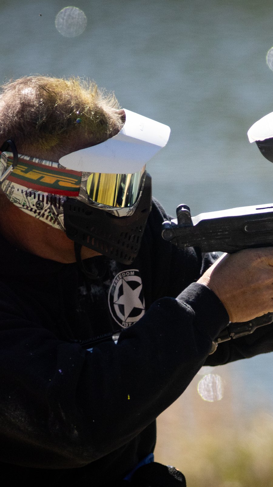Player sighting down a rental marker at the pond field